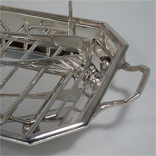 An Art Deco style Silver Plated asparagus serving set, having a plain elongated octagonal body, with an applied reeded border and two cast side-handles, a wire-work serving rack, a sauce boat sat in a frame with loop handle, a pair of asparagus server tongs, and all sitting on a flat base. All pieces are original and were made in England, circa 1930. The dimensions of this fine hand-made silver-plated Art Deco asparagus serving set are length 32.5 cms (12.75 inches), and width, 20 cms (8 inches).