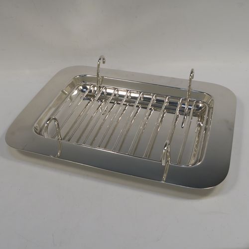 An Antique Edwardian Silver Plated asparagus serving set, having a plain rectangular body, with a wire-work serving rack, and a pair of asparagus server tongs, and all sitting on a flat base. This beautiful asparagus server set was made by the Atkins Brothers of Sheffield in ca. 1910. The dimensions of this fine hand-made silver-plated asparagus serving set are length 30.5 cms (12 inches), and width, 24 cms (9.5 inches). Please note that the asparagus servers are monogrammed, and the base has very light scratches, but everything else is in very good original condition, with no plate wearing off.