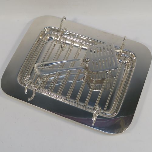 An Antique Edwardian Silver Plated asparagus serving set, having a plain rectangular body, with a wire-work serving rack, and a pair of asparagus server tongs, and all sitting on a flat base. This beautiful asparagus server set was made by the Atkins Brothers of Sheffield in ca. 1910. The dimensions of this fine hand-made silver-plated asparagus serving set are length 30.5 cms (12 inches), and width, 24 cms (9.5 inches). Please note that the asparagus servers are monogrammed, and the base has very light scratches, but everything else is in very good original condition, with no plate wearing off.