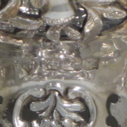 Antique Victorian large sterling silver table basket, in an asymmetrical Art Nouveau style, having an oval hand-pierced body with hand-chased floral decoration, with cast floral and bead-edged borders, and sitting on a matching pedestal foot. Made by Martin Hall & Co., of Sheffield in 1892. The dimensions of this fine hand-made silver basket are length 27.5 cms (10.75 inches), width 23 cms (9 inches), height 21.5 cms (8.5 inches), and it weighs approx. 1,100g (35.5 troy ounces).