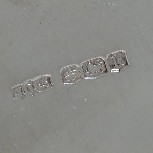A very pretty Sterling Silver basket, having an oval body with an applied gadroon border, all hand-pierced with floral and scroll decoration, a hinged and pierced swing handle, and all sitting on four cast flange feet. Made by James Dixon and Sons of Sheffield in 1927. The dimensions of this fine hand-made silver basket are height 20 cms (8 inches), length 28 cms (11 inches), width 20 cms (8 inches), and it weighs approx. 548g (17.7 troy ounces).