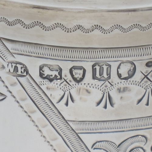 A very pretty and large Antique Victorian Sterling Silver beaker, having a round straight-sided body with tapering sides, with hand-engraved scroll and floral decoration surrounding four vacant cartouches, a gold-gilt interior, and all sitting on a flat base. Made by William Evans of London in 1875. The dimensions of this fine hand-made antique silver beaker are height 12.5 cms (5 inches), diameter at top 8 cms (3 inches), and it weighs approx. 170g (5.5 troy ounces).