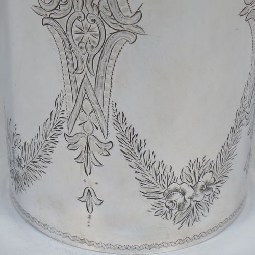 A very pretty and large Antique Victorian Sterling Silver beaker, having a round straight-sided body with tapering sides, with hand-engraved scroll and floral decoration surrounding four vacant cartouches, a gold-gilt interior, and all sitting on a flat base. Made by William Evans of London in 1875. The dimensions of this fine hand-made antique silver beaker are height 12.5 cms (5 inches), diameter at top 8 cms (3 inches), and it weighs approx. 170g (5.5 troy ounces).