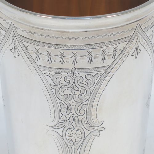 A very pretty and large Antique Victorian Sterling Silver beaker, having a round straight-sided body with tapering sides, with hand-engraved scroll and floral decoration surrounding four vacant cartouches, a gold-gilt interior, and all sitting on a flat base. Made by William Evans of London in 1875. The dimensions of this fine hand-made antique silver beaker are height 12.5 cms (5 inches), diameter at top 8 cms (3 inches), and it weighs approx. 170g (5.5 troy ounces).