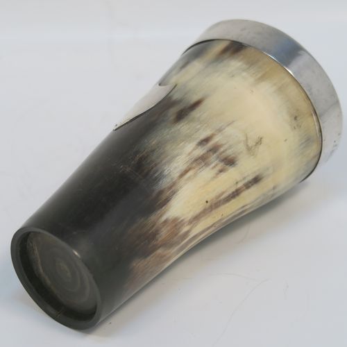 A rare and handsome Antique Sterling Silver and horn beaker cup, having a very plain round horn-mounted body with tapering sides, an applied top silver band around the lip, an applied central shield style vacant cartouche, and all sitting on a flat base. This elegant silver and horn beaker was made by John Grinsell and Sons of Birmingham in 1913. The dimensions of this fine hand-made antique horn and silver beaker cup are height 13cms (5 inches), and diameter at top 7 cms (2.75 inches).