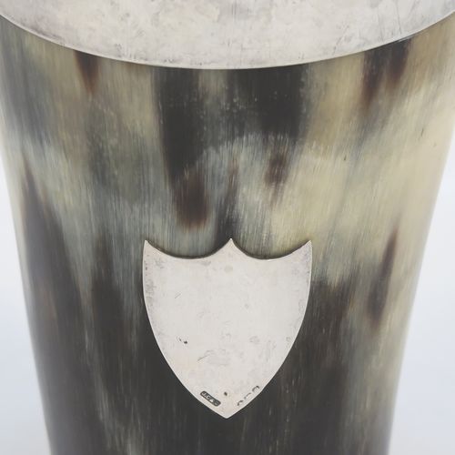 A rare and handsome Antique Sterling Silver and horn beaker cup, having a very plain round horn-mounted body with tapering sides, an applied top silver band around the lip, an applied central shield style vacant cartouche, and all sitting on a flat base. This elegant silver and horn beaker was made by John Grinsell and Sons of Birmingham in 1913. The dimensions of this fine hand-made antique horn and silver beaker cup are height 13cms (5 inches), and diameter at top 7 cms (2.75 inches).