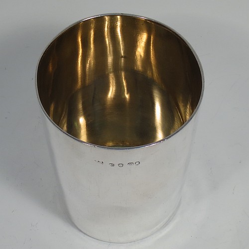 A very handsome Antique Georgian Sterling Silver beaker cup, having a very plain round body with tapering sides, sitting on a flat base, and with a gold-gilt interior. Made by Philip Batchelor (poss.) of London in 1789. The dimensions of this fine hand-made antique silver beaker cup are height 9 cms (3.5 inches), diameter at top 7.5 cms (3 inches), and it weighs approx. 116g (3.7 troy ounces).