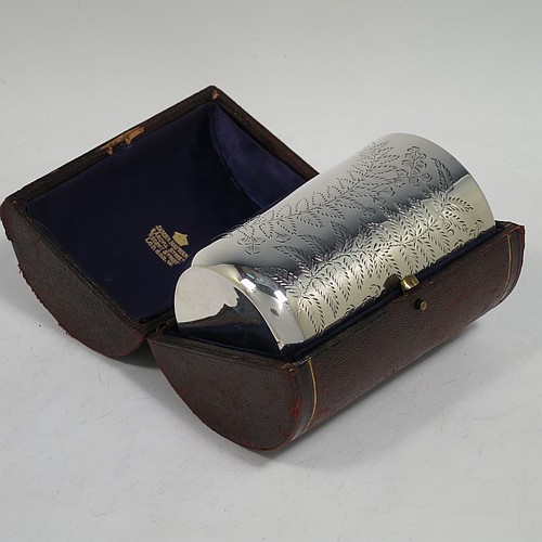 An Antique Victorian Sterling Silver beaker, having a round straight-sided body with tucked under flat base, with hand-engraved fern-work, two vacant oval cartouches on either side, with a gold-gilt interior, and in its original dark blue satin and velvet-lined presentation box. Made by Wakely and Wheeler of London in 1887. The dimensions of this fine hand-made antique silver beaker are height 10 cms (4 inches), diameter at top 7 cms (2.75 inches), and it weighs approx. 129g (4.2 troy ounces). Please note that the box is embossed with initials on the exterior.