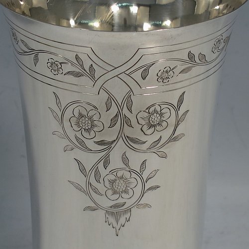 A Sterling Silver beaker in a 17th Century Charles I style, having a round straight-sided body with tapering sides, with hand-engraved floral work, all sitting on a hand-chased collet foot with an applied reeded band above. Made by Robert Frederick Fox of London in 1917. The dimensions of this fine hand-made silver beaker are height 13 cms (5 inches), diameter at top 8 cms (3 inches), and it weighs approx. 226g (7.3 troy ounces).