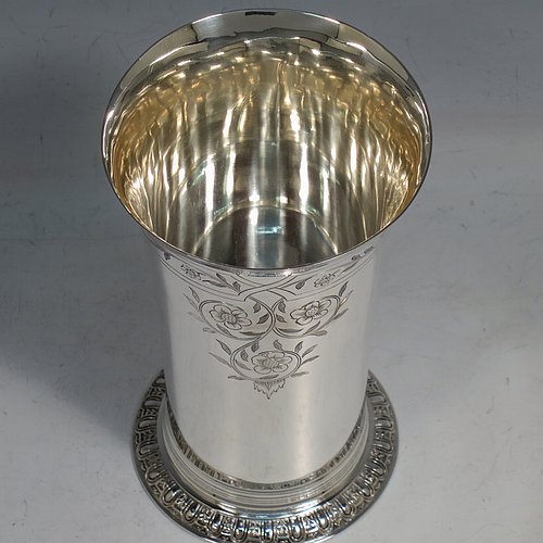 A Sterling Silver beaker in a 17th Century Charles I style, having a round straight-sided body with tapering sides, with hand-engraved floral work, all sitting on a hand-chased collet foot with an applied reeded band above. Made by Robert Frederick Fox of London in 1917. The dimensions of this fine hand-made silver beaker are height 13 cms (5 inches), diameter at top 8 cms (3 inches), and it weighs approx. 226g (7.3 troy ounces).