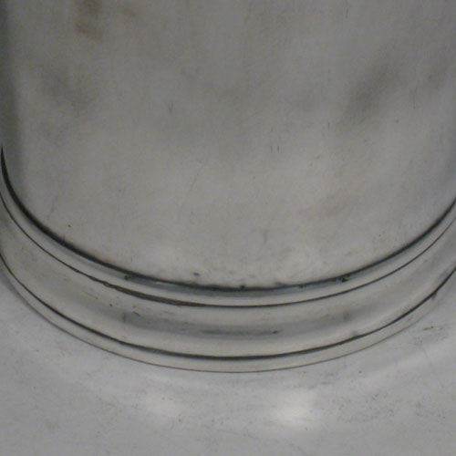 Antique Georgian sterling silver beaker, having a very plain round body with tapering sides, a reeded top border, and sitting on a collet foot. Made by Henry Chawner of London in 1787. The dimensions of this fine hand-made silver beaker are height 9.5 cms (3.75 inches), diameter at top 8 cms (3 inches), and it weighs approx. 152g (4.9 troy ounces).