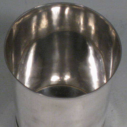 Antique Georgian sterling silver beaker, having a very plain round body with tapering sides, a reeded top border, and sitting on a collet foot. Made by Henry Chawner of London in 1787. The dimensions of this fine hand-made silver beaker are height 9.5 cms (3.75 inches), diameter at top 8 cms (3 inches), and it weighs approx. 152g (4.9 troy ounces).