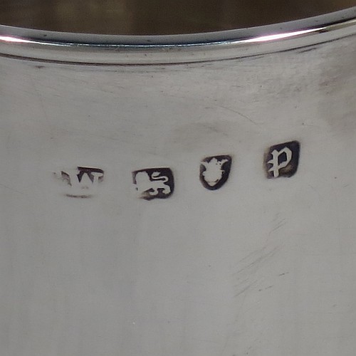 A very handsome Antique Georgian Sterling Silver beaker, having a very plain round body with tapering sides, reeded top and bottom borders, and sitting on a collet foot. Made by Thomas Wallis I of London in 1770. The dimensions of this fine hand-made antique silver beaker are height 9 cms (3.5 inches), diameter at top 7 cms (2.75 inches), and it weighs approx. 123g (4 troy ounces).