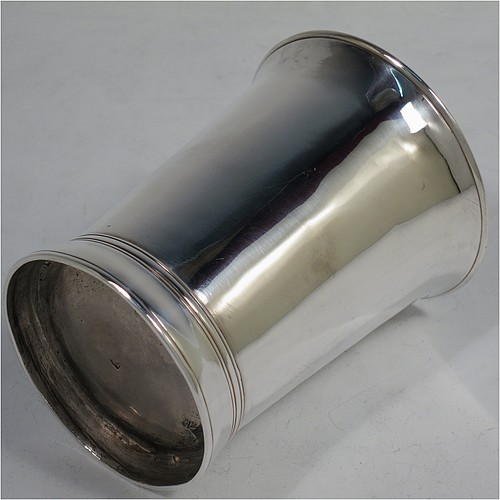 A very handsome Antique Georgian Sterling Silver beaker, having a very plain round body with tapering sides, reeded top and bottom borders, and sitting on a collet foot. Made by Thomas Wallis I of London in 1770. The dimensions of this fine hand-made antique silver beaker are height 9 cms (3.5 inches), diameter at top 7 cms (2.75 inches), and it weighs approx. 123g (4 troy ounces).