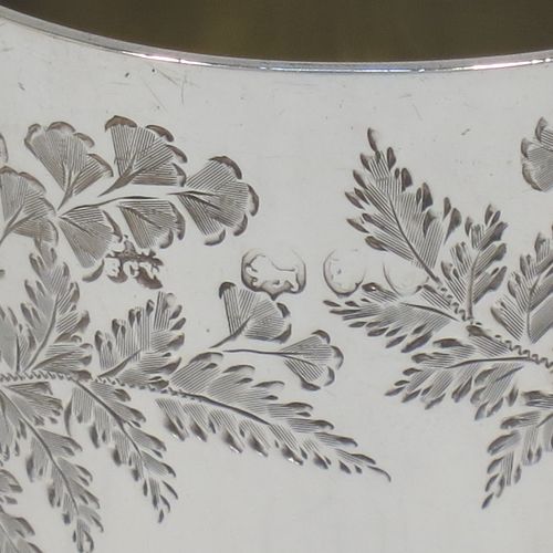 A very pretty Antique Victorian Sterling Silver beaker, having a round straight-sided body with tapering sides and a tucked under base, with hand-engraved ferns and gingko leaves surrounding two vacant cartouches either side, a gold-gilt interior and all sitting on a flat base. Made by F. C. W. Ltd., of London in 1889. The dimensions of this fine hand-made antique silver beaker are height 9 cms (3.5 inches), diameter at top 6 cms (2.25 inches), and it weighs approx. 75g (2.4 troy ounces).