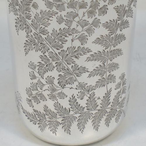 A very pretty Antique Victorian Sterling Silver beaker, having a round straight-sided body with tapering sides and a tucked under base, with hand-engraved ferns and gingko leaves surrounding two vacant cartouches either side, a gold-gilt interior and all sitting on a flat base. Made by F. C. W. Ltd., of London in 1889. The dimensions of this fine hand-made antique silver beaker are height 9 cms (3.5 inches), diameter at top 6 cms (2.25 inches), and it weighs approx. 75g (2.4 troy ounces).