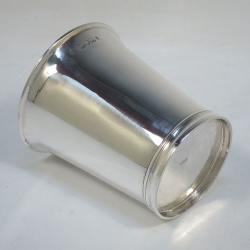 A very handsome Antique Victorian Sterling Silver beaker cup, having a very plain round body with tapering sides, and sitting on a collet foot with reeded decoration. Made by Walter and Harold Child of London in 1898. The dimensions of this fine hand-made antique silver beaker cup are height 9.5 cms (3.75 inches), diameter at top 8.5 cms (3.3 inches), and it weighs approx. 134g (4.3 troy ounces).