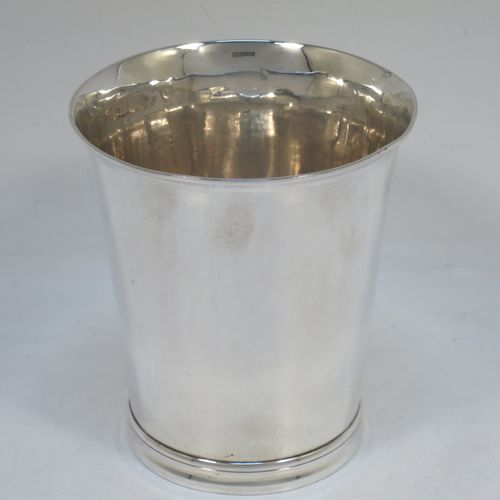 A very handsome Antique Victorian Sterling Silver beaker cup, having a very plain round body with tapering sides, and sitting on a collet foot with reeded decoration. Made by Walter and Harold Child of London in 1898. The dimensions of this fine hand-made antique silver beaker cup are height 9.5 cms (3.75 inches), diameter at top 8.5 cms (3.3 inches), and it weighs approx. 134g (4.3 troy ounces).