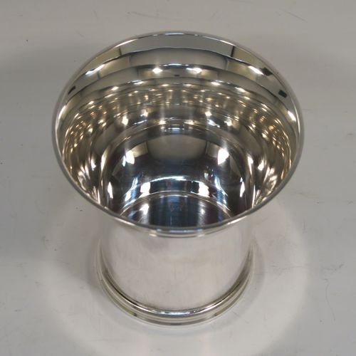 A heavy and very handsome Sterling Silver beaker cup, having a plain round body with tapering flared sides, and sitting on a collet foot with an applied reeded border. This elegant silver beaker was made by Munsey and Co., of London in 1938. The dimensions of this fine hand-made silver beaker cup are height 9 cms (3.5 inches), diameter at top 9 cms (3.5 inches), and it weighs approx. 237g (7.6 troy ounces).