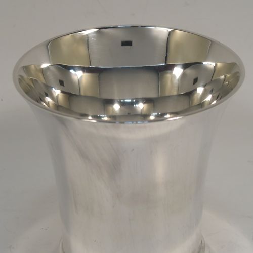 A heavy and very handsome Sterling Silver beaker cup, having a plain round body with tapering flared sides, and sitting on a collet foot with an applied reeded border. This elegant silver beaker was made by Munsey and Co., of London in 1938. The dimensions of this fine hand-made silver beaker cup are height 9 cms (3.5 inches), diameter at top 9 cms (3.5 inches), and it weighs approx. 237g (7.6 troy ounces).