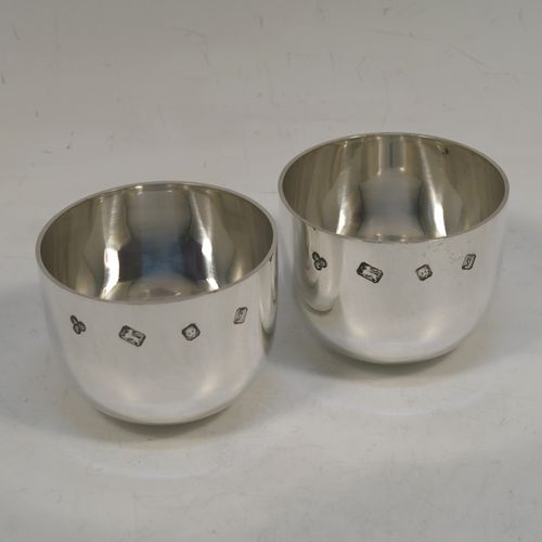 A very handsome and heavy pair of Sterling Silver tumbler cups, having plain round bodies. These beautiful silver tumbler cups were made by Payne and Son of  London in 1983. The dimensions of these fine hand-made silver tumbler cups are height 5 cms (2 inches), diameter 6.5 cms (2.5 inches), and their total weight is approx. 356g (11.5 troy ounces).  