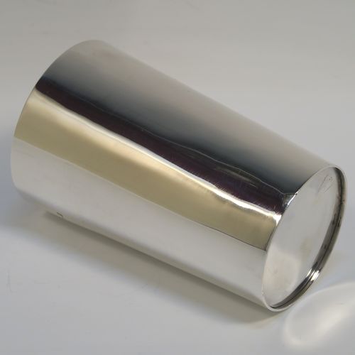 A handsome Antique Victorian Sterling Silver beaker cup, having a very plain round body with tapering sides, a gold-gilt interior, and sitting on a flat base. This elegant antique silver beaker was made by Nathan and Hayes of Chester in 1895. The dimensions of this fine hand-made antique silver beaker cup are height 11cms (4.25 inches), diameter at top 7 cms (2.75 inches), and it weighs approx. 115g (3.7 troy ounces).