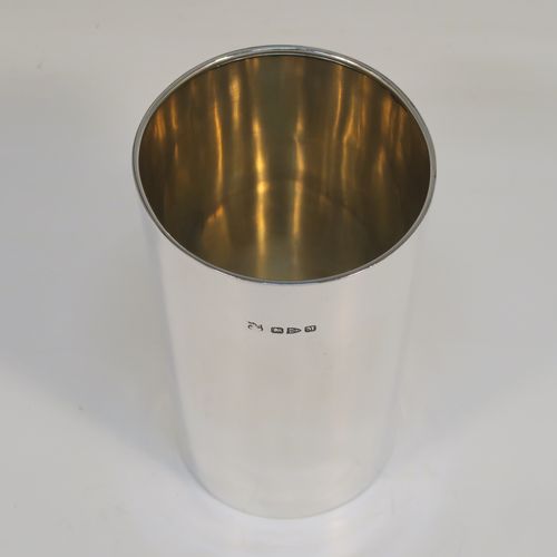 A handsome Antique Victorian Sterling Silver beaker cup, having a very plain round body with tapering sides, a gold-gilt interior, and sitting on a flat base. This elegant antique silver beaker was made by Nathan and Hayes of Chester in 1895. The dimensions of this fine hand-made antique silver beaker cup are height 11cms (4.25 inches), diameter at top 7 cms (2.75 inches), and it weighs approx. 115g (3.7 troy ounces).