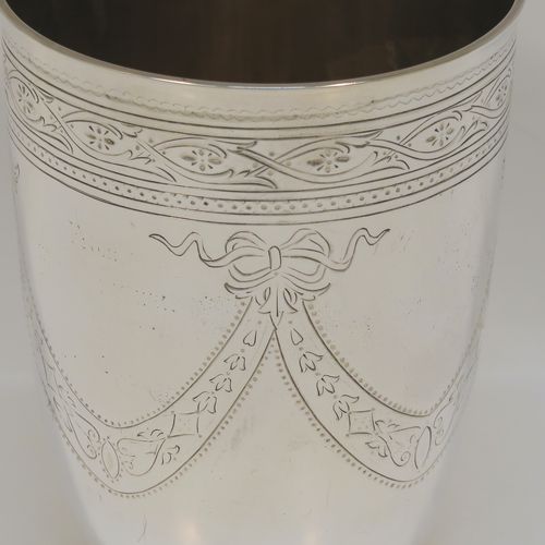 A beautiful Antique Victorian Sterling Silver beaker, having a round body with tapering sides, with hand-engraved floral and swag decoration, a gold-gilt interior, and all sitting on a collet foot with an applied bead-edged border. This very pretty silver beaker was made in Sheffield in 1874. The dimensions of this fine hand-made antique silver beaker are height 11 cms (4.25 inches), diameter at top 8 cms (3.25 inches), and it weighs approx. 170g (5.5 troy ounces).
