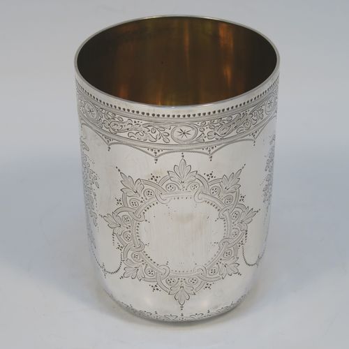 A beautiful Antique Victorian Sterling Silver beaker, having a round body with straight sides, with hand-engraved floral decoration, a gold-gilt interior, and all sitting on a flat base with tucked under belly. This very pretty silver beaker was made by the Barnard Brothers of London in 1877. The dimensions of this fine hand-made antique silver beaker are height 10 cms (4 inches), diameter at top 7 cms (2.75 inches), and it weighs approx. 119g (3.8 troy ounces).   