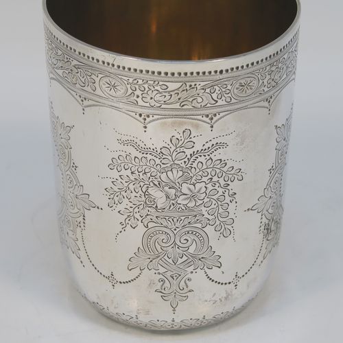 A beautiful Antique Victorian Sterling Silver beaker, having a round body with straight sides, with hand-engraved floral decoration, a gold-gilt interior, and all sitting on a flat base with tucked under belly. This very pretty silver beaker was made by the Barnard Brothers of London in 1877. The dimensions of this fine hand-made antique silver beaker are height 10 cms (4 inches), diameter at top 7 cms (2.75 inches), and it weighs approx. 119g (3.8 troy ounces).