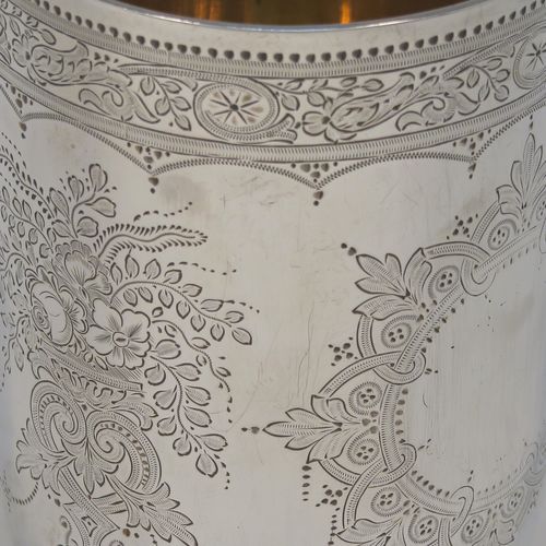 A beautiful Antique Victorian Sterling Silver beaker, having a round body with straight sides, with hand-engraved floral decoration, a gold-gilt interior, and all sitting on a flat base with tucked under belly. This very pretty silver beaker was made by the Barnard Brothers of London in 1877. The dimensions of this fine hand-made antique silver beaker are height 10 cms (4 inches), diameter at top 7 cms (2.75 inches), and it weighs approx. 119g (3.8 troy ounces).