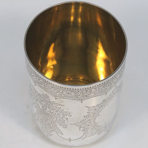 A beautiful Antique Victorian Sterling Silver beaker, having a round body with straight sides, with hand-engraved floral decoration, a gold-gilt interior, and all sitting on a flat base with tucked under belly. This very pretty silver beaker was made by the Barnard Brothers of London in 1877. The dimensions of this fine hand-made antique silver beaker are height 10 cms (4 inches), diameter at top 7 cms (2.75 inches), and it weighs approx. 119g (3.8 troy ounces).