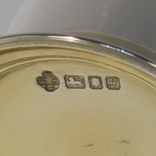 A heavy and very handsome Sterling Silver beaker cup, having a plain round body with tapering flared sides, and sitting on a collet foot with an applied reeded border, together with a gold-gilt interior and upper band. This elegant silver beaker was made by the Marlow Brothers of London in 1998. The dimensions of this fine hand-made silver beaker cup are height 11.5 cms (4.5 inches), diameter at top 7.5 cms (3 inches), and it weighs approx. 206g (6.6 troy ounces).