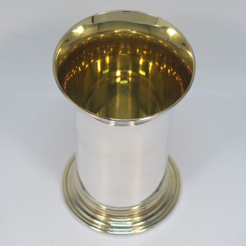 A heavy and very handsome Sterling Silver beaker cup, having a plain round body with tapering flared sides, and sitting on a collet foot with an applied reeded border, together with a gold-gilt interior and upper band. This elegant silver beaker was made by the Marlow Brothers of London in 1998. The dimensions of this fine hand-made silver beaker cup are height 11.5 cms (4.5 inches), diameter at top 7.5 cms (3 inches), and it weighs approx. 206g (6.6 troy ounces).
