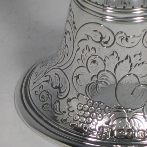 Antique Georgian sterling silver table bell having a round baluster body with hand-chased fruit and floral decoration, a cast octagonal handle, and an original silver clapper. Made by the Lias Brothers of London in 1828. The dimensions of this fine hand-made antique silver table bell are height 14 cms (5.5 inches), diameter at base 8 cms (3 inches), and it weighs approx. 225g (7.3 troy ounces).