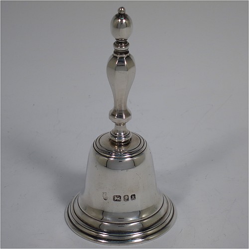A Sterling Silver Georgian style table bell having a plain round body with applied reeded borders, a cast hexagonal baluster handle, and an original silver clapper. Made by C. J. Vander of London in 1965. The dimensions of this fine hand-made silver table bell are height 11.5 cms (4.5 inches), diameter at base 5.5 cms (2.25 inches), and it weighs approx. 168g (5.4 troy ounces).   