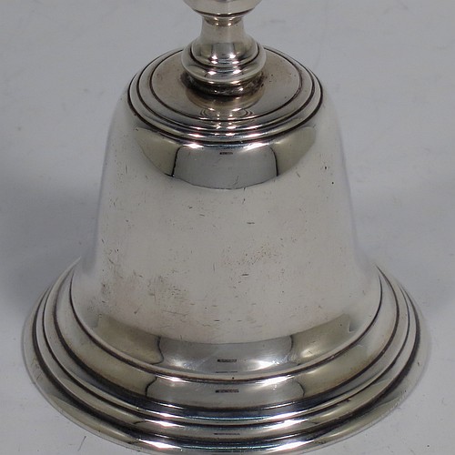 A Sterling Silver Georgian style table bell having a plain round body with applied reeded borders, a cast hexagonal baluster handle, and an original silver clapper. Made by C. J. Vander of London in 1965. The dimensions of this fine hand-made silver table bell are height 11.5 cms (4.5 inches), diameter at base 5.5 cms (2.25 inches), and it weighs approx. 168g (5.4 troy ounces).