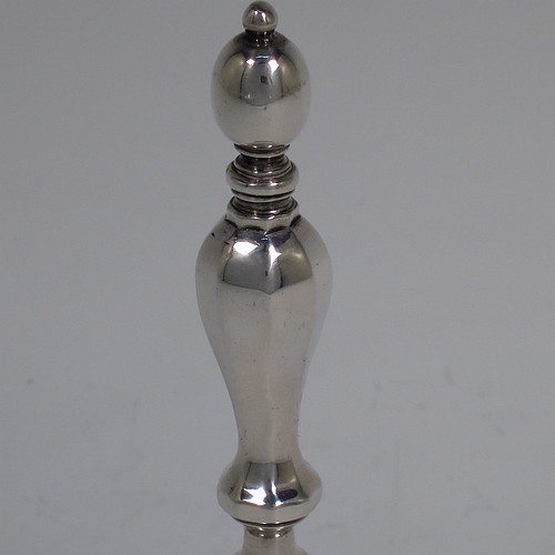 A Sterling Silver Georgian style table bell having a plain round body with applied reeded borders, a cast hexagonal baluster handle, and an original silver clapper. Made by C. J. Vander of London in 1965. The dimensions of this fine hand-made silver table bell are height 11.5 cms (4.5 inches), diameter at base 5.5 cms (2.25 inches), and it weighs approx. 168g (5.4 troy ounces).