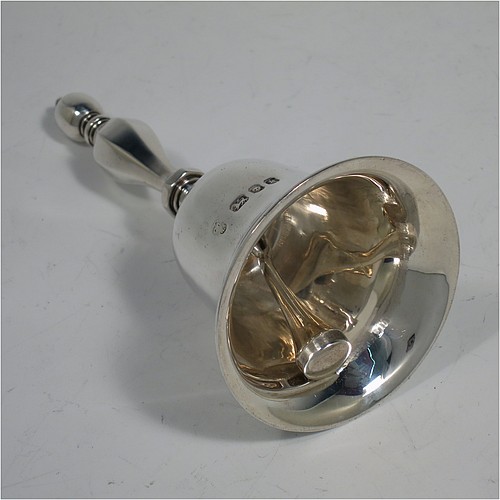 A Sterling Silver Georgian style table bell having a plain round body with applied reeded borders, a cast hexagonal baluster handle, and an original silver clapper. Made by C. J. Vander of London in 1965. The dimensions of this fine hand-made silver table bell are height 11.5 cms (4.5 inches), diameter at base 5.5 cms (2.25 inches), and it weighs approx. 168g (5.4 troy ounces).