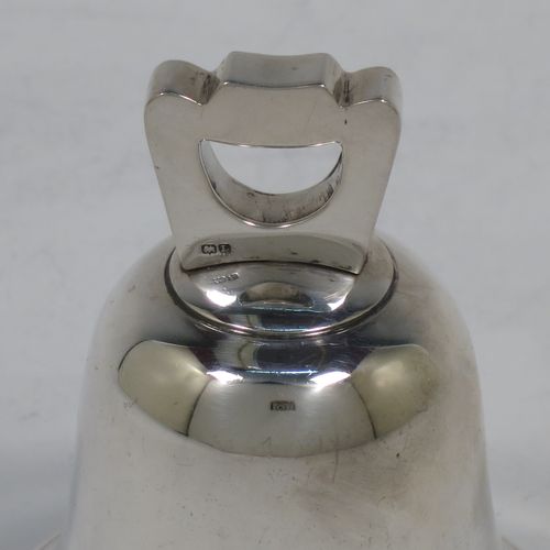 A handsome Sterling Silver table bell having a plain round body with a cast canon style handle, and an original silver clapper. Made by Mappin and Webb of Birmingham in 1935. The dimensions of this fine hand-made silver table bell are height 8 cms (3 inches), diameter at base 6.5 cms (2.6 inches), and it weighs approx. 120g (3.8 troy ounces).