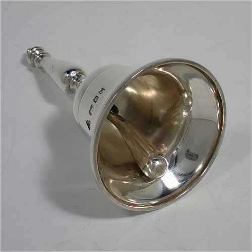 A very handsome Sterling Silver Georgian style table bell having a plain round body with applied reeded borders, a cast round baluster handle, and an original silver clapper. Made by Wakely and Wheeler of London in 1972. The dimensions of this fine hand-made silver table bell are height 10 cms (4 inches), diameter at base 6 cms (2.3 inches), and it weighs approx. 150g (4.8 troy ounces).