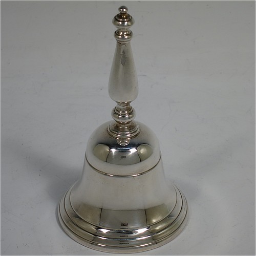 A very handsome Sterling Silver Georgian style table bell having a plain round body with applied reeded borders, a cast round baluster handle, and an original silver clapper. Made by Wakely and Wheeler of London in 1972. The dimensions of this fine hand-made silver table bell are height 10 cms (4 inches), diameter at base 6 cms (2.3 inches), and it weighs approx. 150g (4.8 troy ounces).
