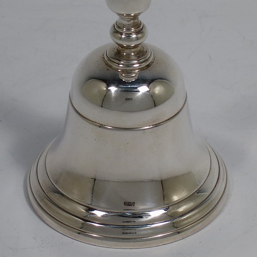 A very handsome Sterling Silver Georgian style table bell having a plain round body with applied reeded borders, a cast round baluster handle, and an original silver clapper. Made by Wakely and Wheeler of London in 1972. The dimensions of this fine hand-made silver table bell are height 10 cms (4 inches), diameter at base 6 cms (2.3 inches), and it weighs approx. 150g (4.8 troy ounces).