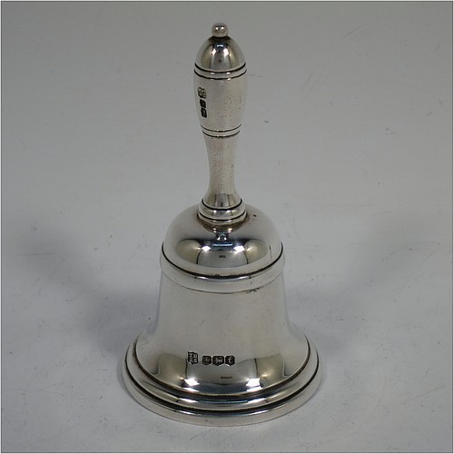 A very handsome Sterling Silver Georgian style table bell having a plain round body with applied reeded borders, a cast round baluster handle, and an original silver clapper. Made by Thomas Bradbury and Sons of Sheffield in 1936. The dimensions of this fine hand-made silver table bell are height 10.5 cms (4 inches), diameter at base 6 cms (2.25 inches), and it weighs approx. 151g (4.9 troy ounces).
	   