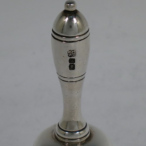 A very handsome Sterling Silver Georgian style table bell having a plain round body with applied reeded borders, a cast round baluster handle, and an original silver clapper. Made by Thomas Bradbury and Sons of Sheffield in 1936. The dimensions of this fine hand-made silver table bell are height 10.5 cms (4 inches), diameter at base 6 cms (2.25 inches), and it weighs approx. 151g (4.9 troy ounces).
	   