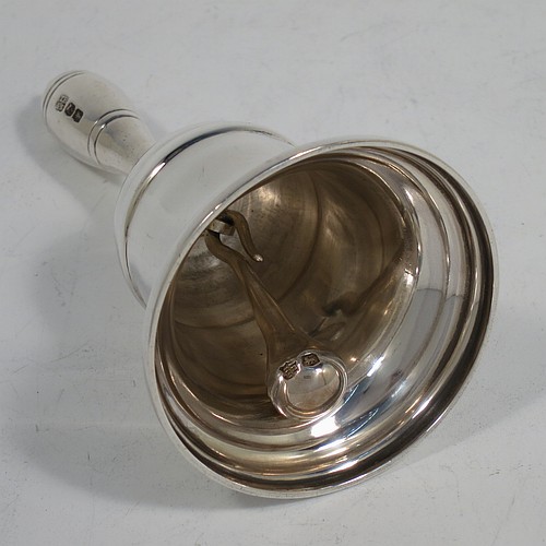 A very handsome Sterling Silver Georgian style table bell having a plain round body with applied reeded borders, a cast round baluster handle, and an original silver clapper. Made by Thomas Bradbury and Sons of Sheffield in 1936. The dimensions of this fine hand-made silver table bell are height 10.5 cms (4 inches), diameter at base 6 cms (2.25 inches), and it weighs approx. 151g (4.9 troy ounces).
	   