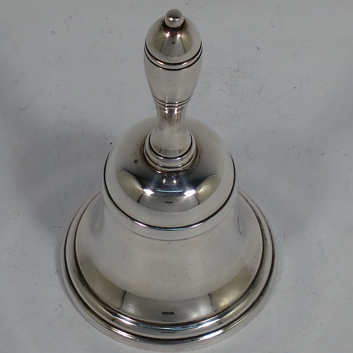 A very handsome Sterling Silver Georgian style table bell having a plain round body with applied reeded borders, a cast round baluster handle, and an original silver clapper. Made by Thomas Bradbury and Sons of Sheffield in 1936. The dimensions of this fine hand-made silver table bell are height 10.5 cms (4 inches), diameter at base 6 cms (2.25 inches), and it weighs approx. 151g (4.9 troy ounces).
	   
