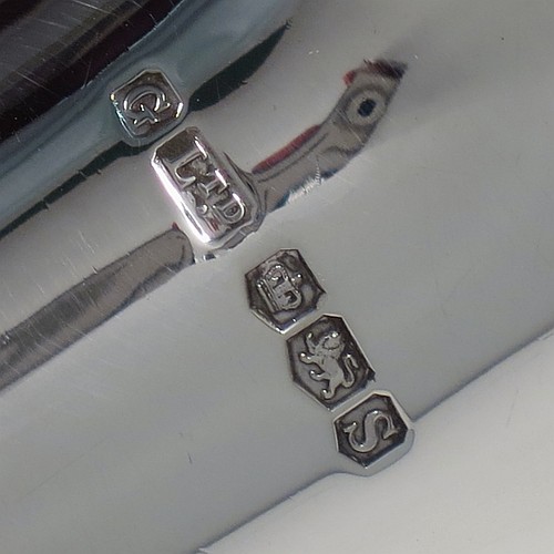 A Sterling Silver pair of Georgian style table bells, having plain round bellied bodies, with hand-turned wooden handles, and original silver clappers, all in their original cream satin and black velvet-lined presentation box. Made by Gladwin and Co., Ltd., of Sheffield in 1935. The dimensions of this fine hand-made pair of silver table bells are height 11.5 cms (4.5 inches), diameter at base 6.5 cms (2.5 inches), and they weigh a total of approx. 280g (9 troy ounces).