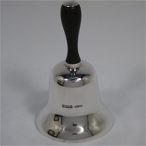 A Sterling Silver pair of Georgian style table bells, having plain round bellied bodies, with hand-turned wooden handles, and original silver clappers, all in their original cream satin and black velvet-lined presentation box. Made by Gladwin and Co., Ltd., of Sheffield in 1935. The dimensions of this fine hand-made pair of silver table bells are height 11.5 cms (4.5 inches), diameter at base 6.5 cms (2.5 inches), and they weigh a total of approx. 280g (9 troy ounces).