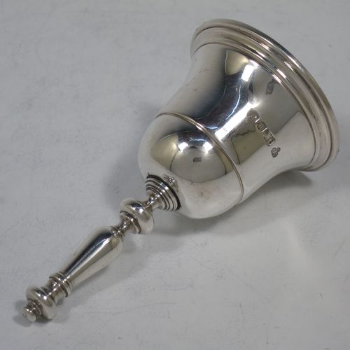 A very handsome Sterling Silver Georgian style table bell having a plain round body with applied reeded borders, a cast round baluster handle, and an original silver clapper. Made by C. J. Vander of London in 1972. The dimensions of this fine hand-made silver table bell are height 10 cms (4 inches), diameter at base 6 cms (2.3 inches), and it weighs approx. 158g (5 troy ounces).    